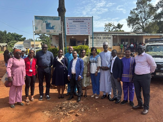 a group of participants in front of a health facility in Uganda